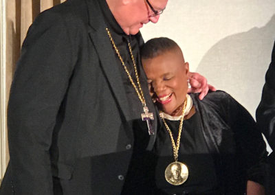…when His Eminence Timothy Michael Cardinal Dolan, Archbishop of New York, adorns you with the Pierre Toussaint Medal, you really do melt in his arms!